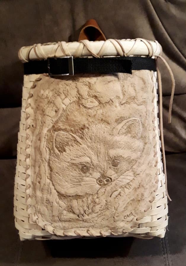 Photo of pack basket with image of a racoon.