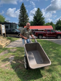 Ed Kipp pushing a wheelbarrow. 