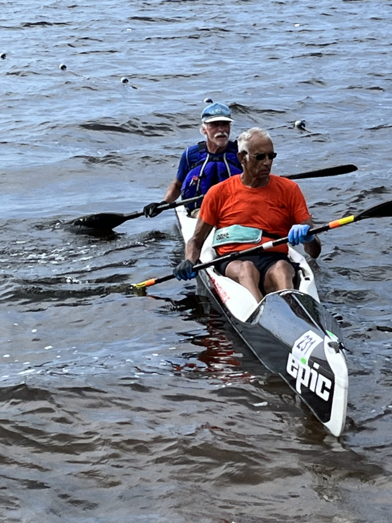 Two men racing in a kayak