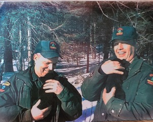 Image of Bernie Siskavich (left) and another forest ranger holding bear cubs