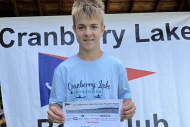 Young man hold kayak race certificate